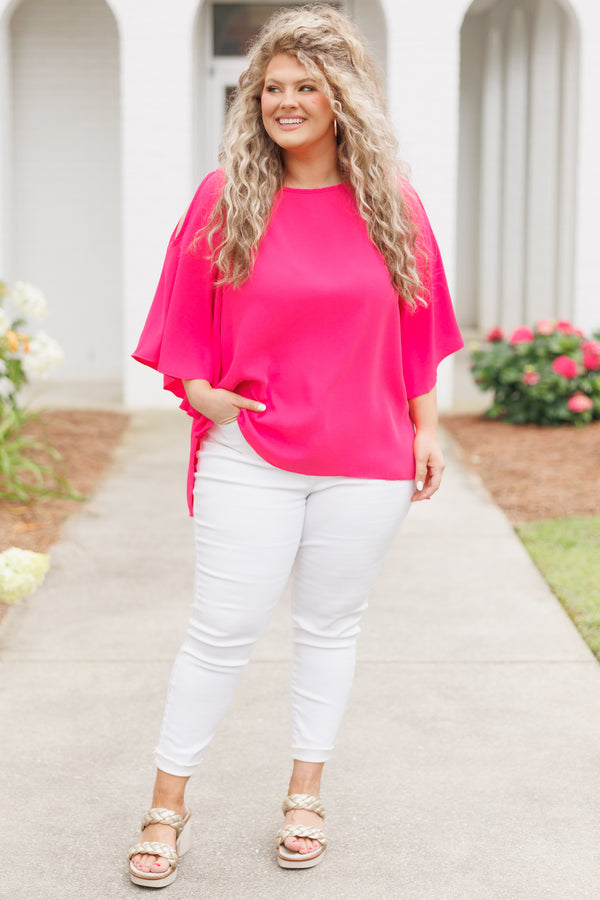 Plus Size hot pink flowy top with cold shoulder sleeves and white denim pants.