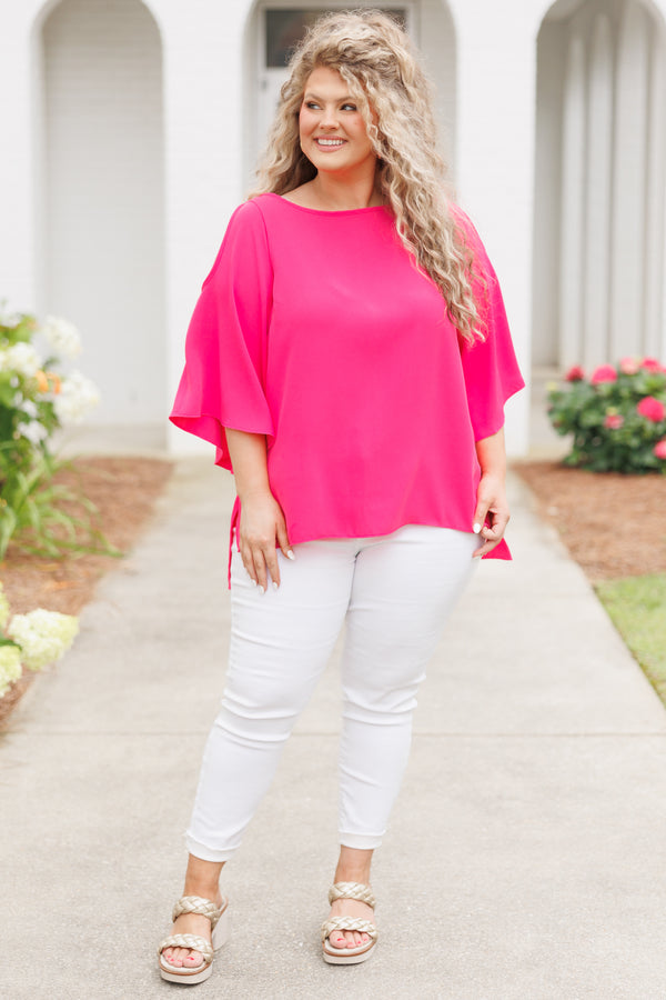 Plus Size hot pink flowy top with cold shoulder sleeves and white denim pants.