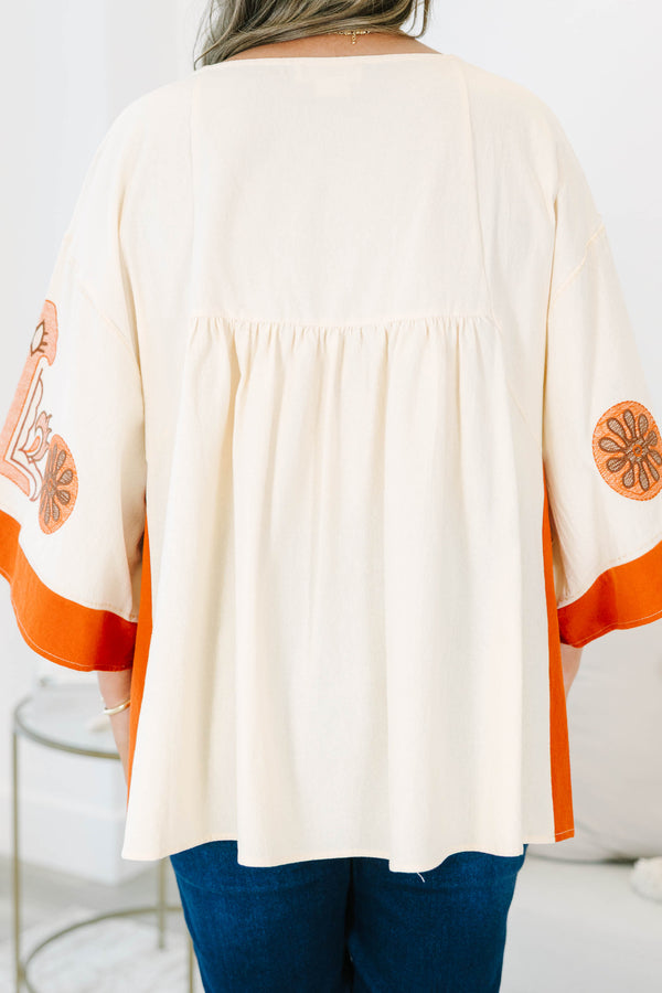 Plus size clothing, cream colored tunic top with orange embroidery