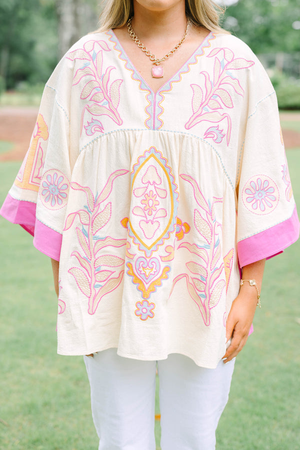Plus Size cream tunic top with pink and yellow embroidery, V-neckline, and wide bell sleeves.