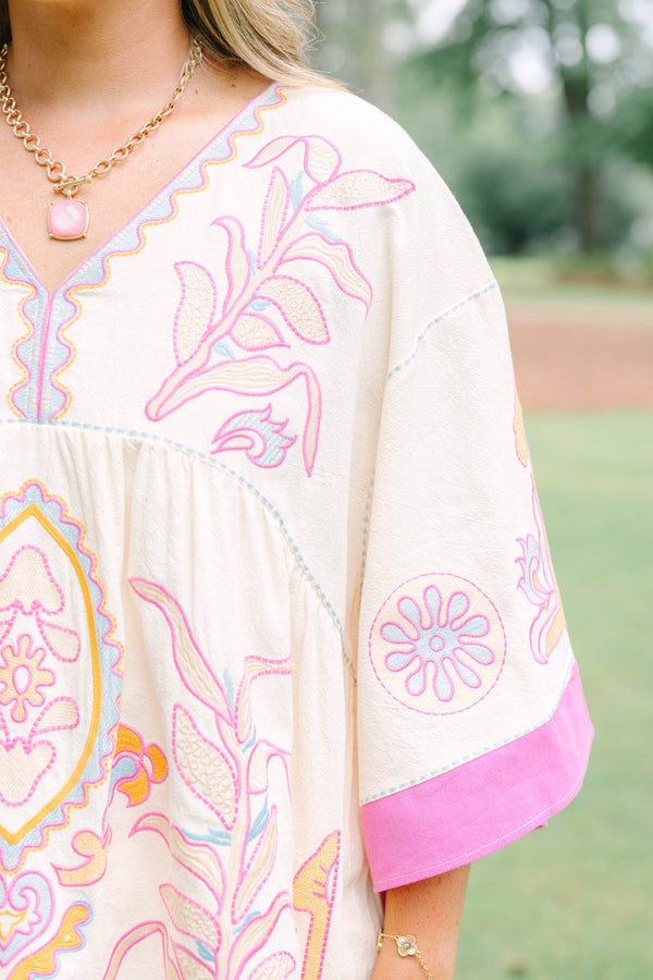 Plus Size cream tunic top with pink and yellow embroidery, V-neckline, and wide bell sleeves.