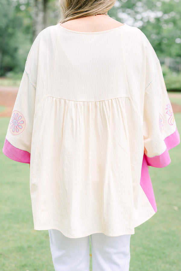 Plus Size cream tunic top with pink and yellow embroidery, V-neckline, and wide bell sleeves.