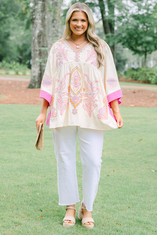 Plus Size cream tunic top with pink and yellow embroidery, V-neckline, and wide bell sleeves.