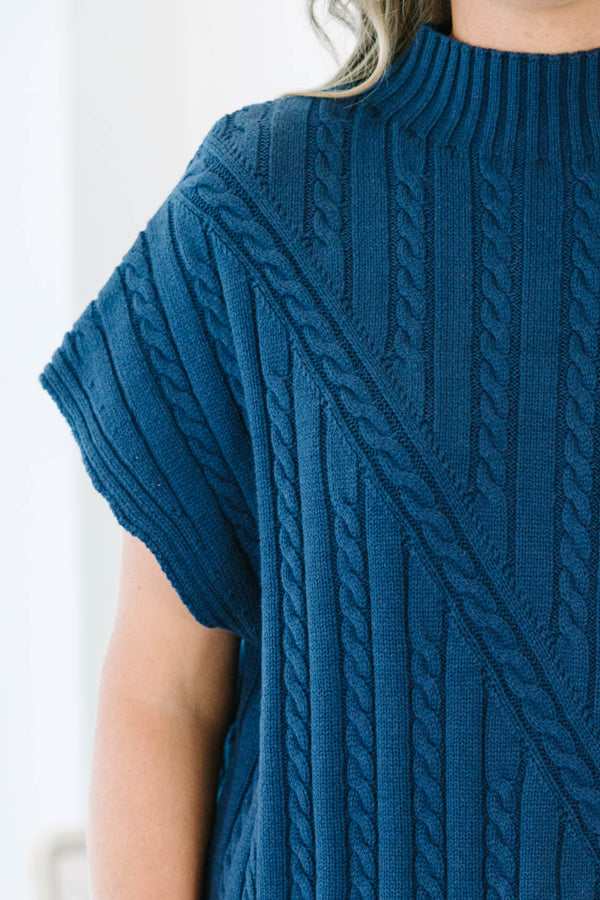 Plus size navy blue sleeveless cable-knit sweater with a mock neckline and diagonal seam detail.