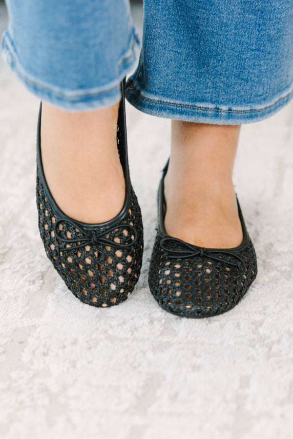 Plus Size black woven mesh ballet flats with a small bow detail paired with blue denim jeans.