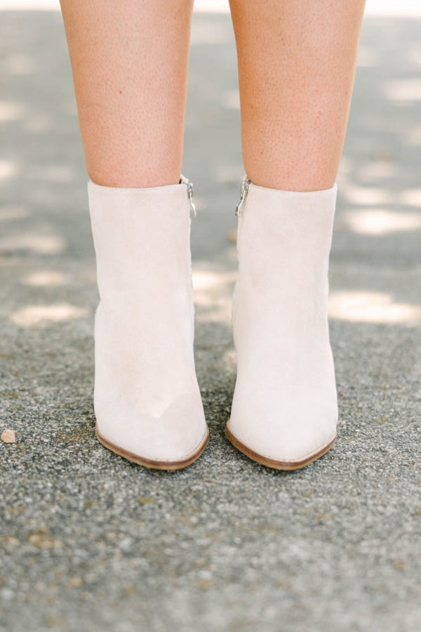 Plus Size beige pointed-toe booties with a block heel and floral daisy embroidery on the back.