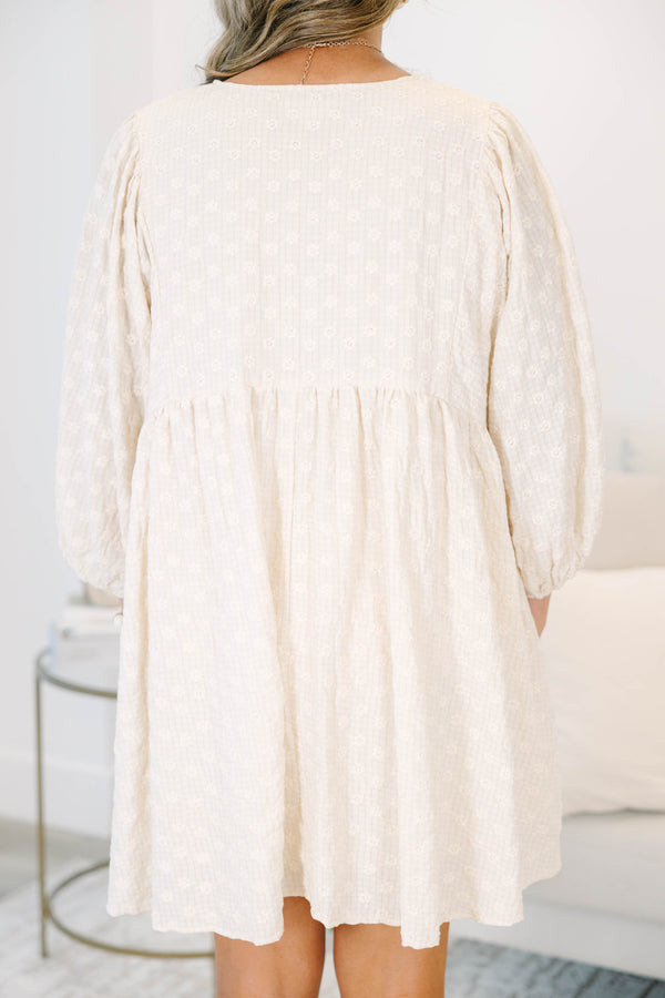 Plus Size cream babydoll dress with a V-neckline, tassel ties, and long balloon sleeves.