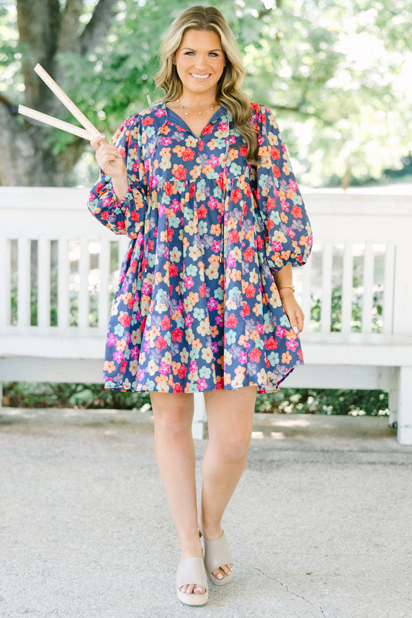 Plus size navy floral mini dress with a flowy fit, V-neckline, and three-quarter length sleeves.