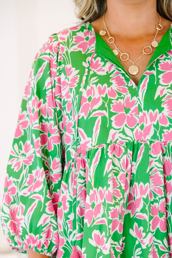 Plus size pink and green floral mini dress with flowy fit, long puff sleeves, and tassel ties.