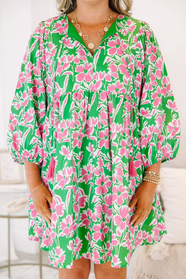Plus size pink and green floral mini dress with flowy fit, long puff sleeves, and tassel ties.