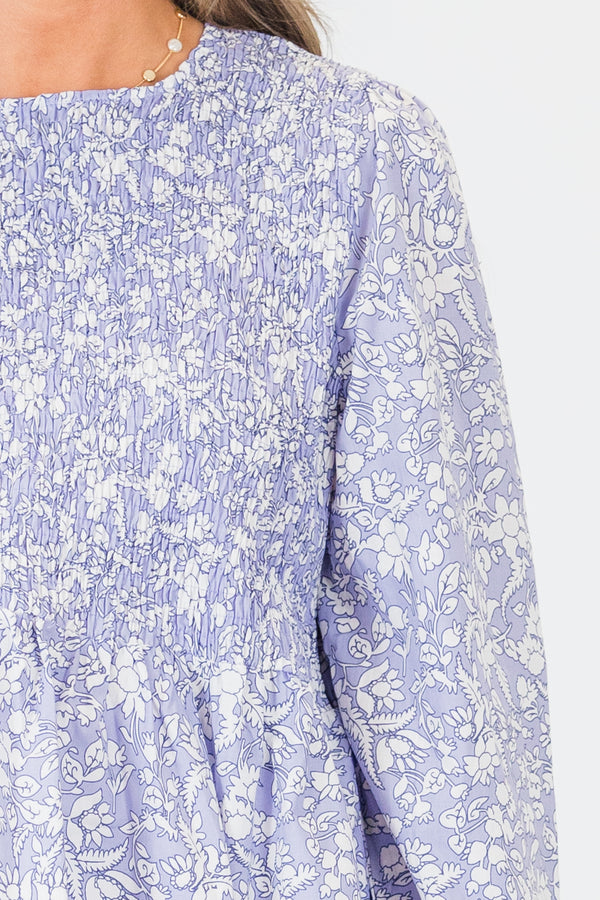Chic Soul plus size clothing, long-sleeve light pale purple ruffled baby doll top with a high-scoop-neckline with a smocked bodice and a small white floral pattern 