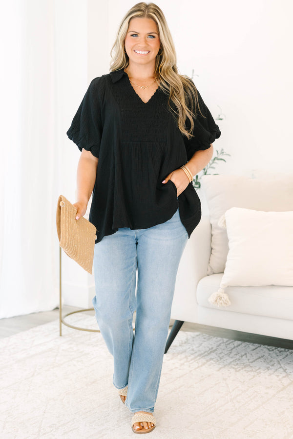 Plus size black cotton top with a flowy fit, smocked bodice, and puff sleeves.