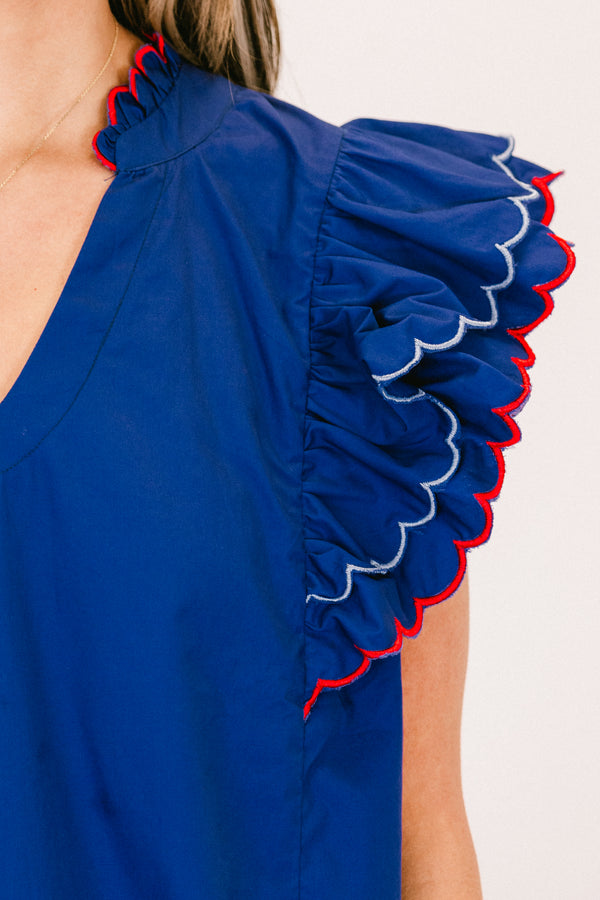 Plus Size navy cotton top with flutter sleeves, scallop trim, and a split v-neckline.