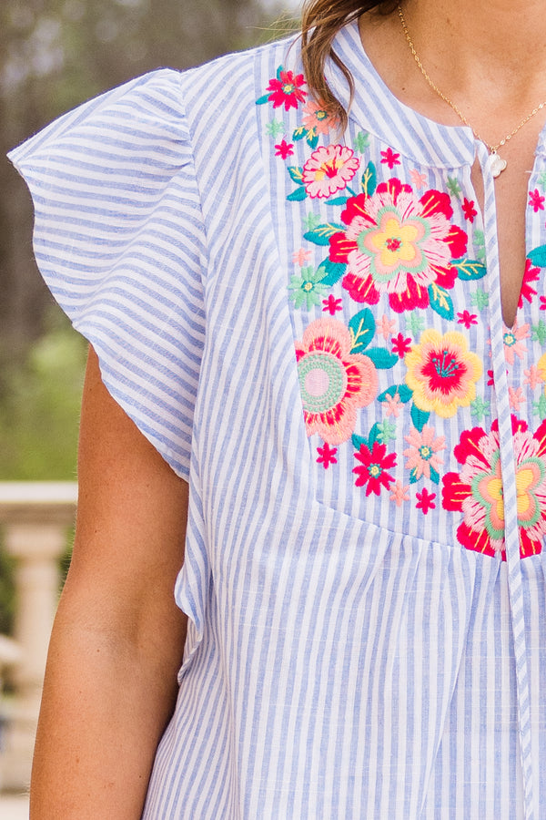 Chic Soul plus size clothing, light denim stripe short sleeve top with ruffle sleeves and v cutout along neckline with drawstring detail and floral design along chest