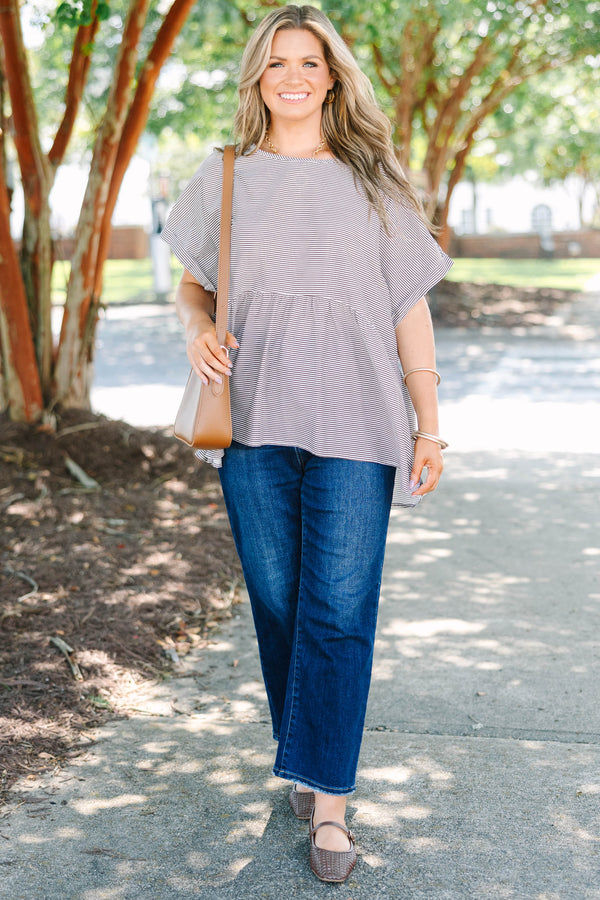 Plus size brown and ivory striped flowy top with a relaxed fit and short flutter sleeves.