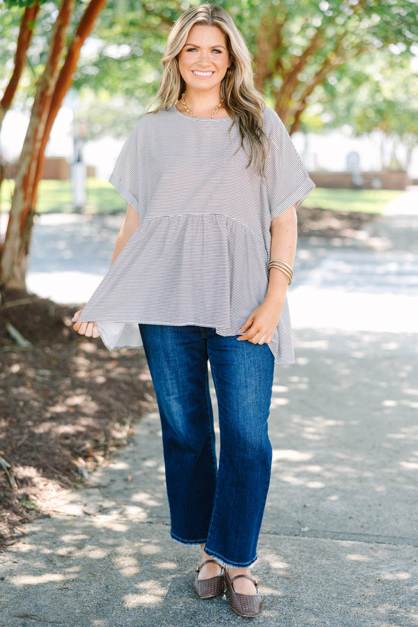 Plus size brown and ivory striped flowy top with a relaxed fit and short flutter sleeves.