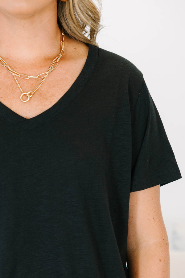 Plus Size black v-neck top with a relaxed fit, short sleeves, and a functional front chest pocket.