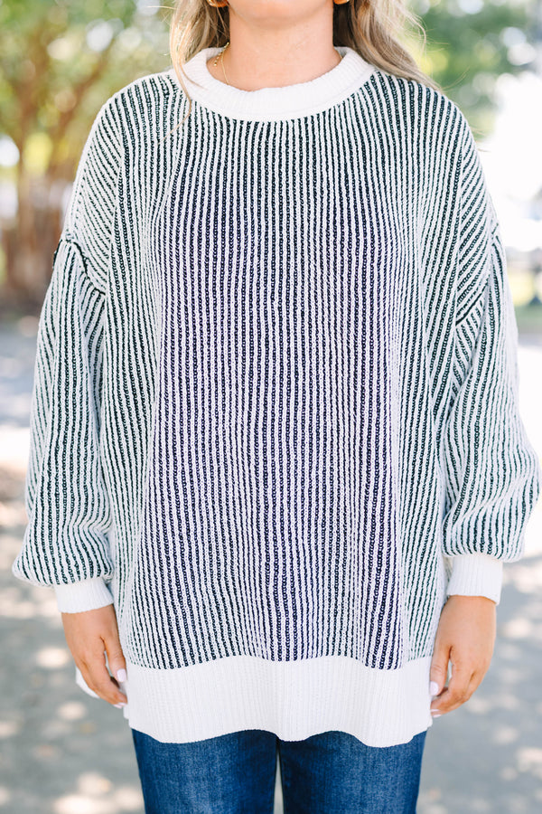 Plus Size oversized black and white vertical striped knit sweater with a crew neck and ribbed trim.