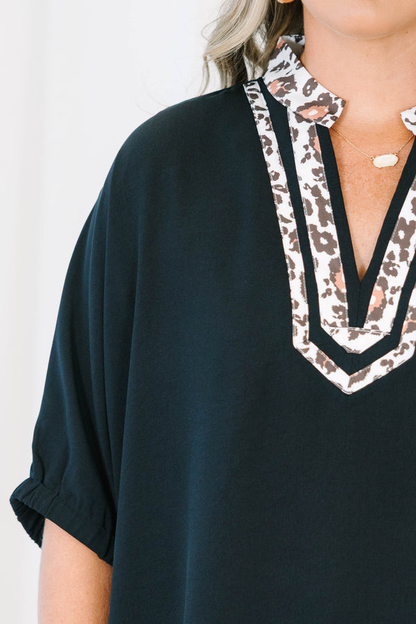 Plus Size black short dolman sleeve top with a leopard print split v-neckline trim.