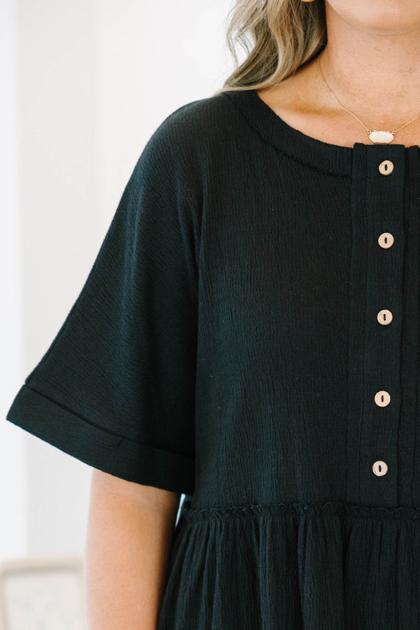 Plus size black cotton-blend babydoll top with button-front detail and a flowy tiered silhouette.