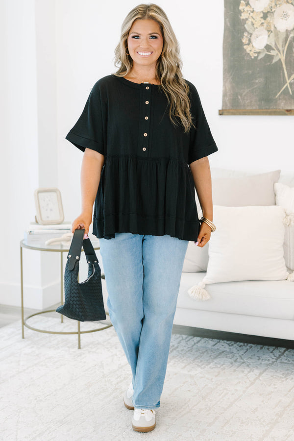 Plus size black cotton-blend babydoll top with button-front detail and a flowy tiered silhouette.