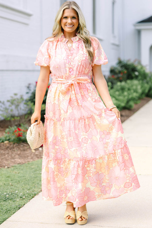 Plus Size pink floral maxi dress with short puff sleeves, a belted waist, and tiered skirt.