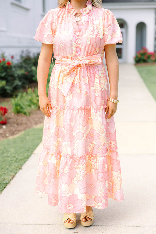 Plus Size pink floral maxi dress with short puff sleeves, a belted waist, and tiered skirt.