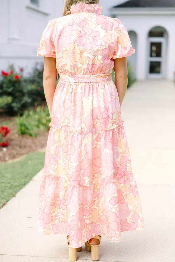 Plus Size pink floral maxi dress with short puff sleeves, a belted waist, and tiered skirt.