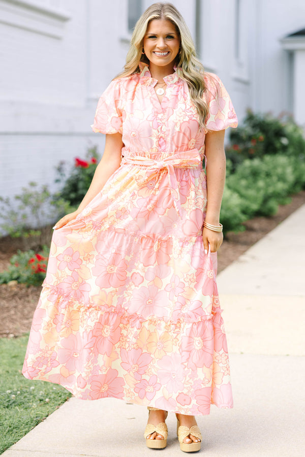 Plus Size pink floral maxi dress with short puff sleeves, a belted waist, and tiered skirt.