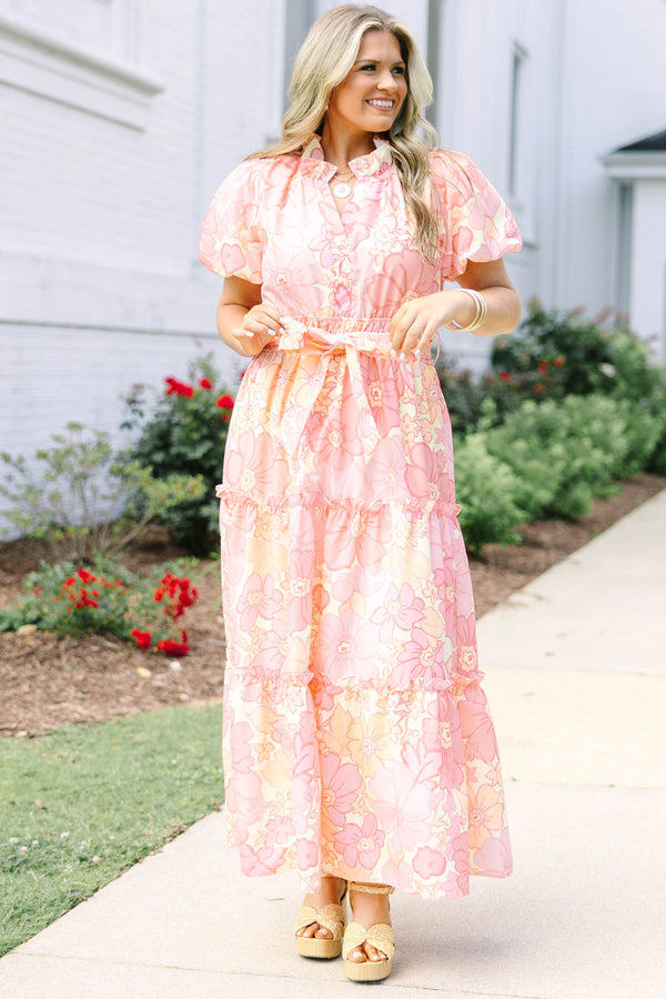 Plus Size pink floral maxi dress with short puff sleeves, a belted waist, and tiered skirt.
