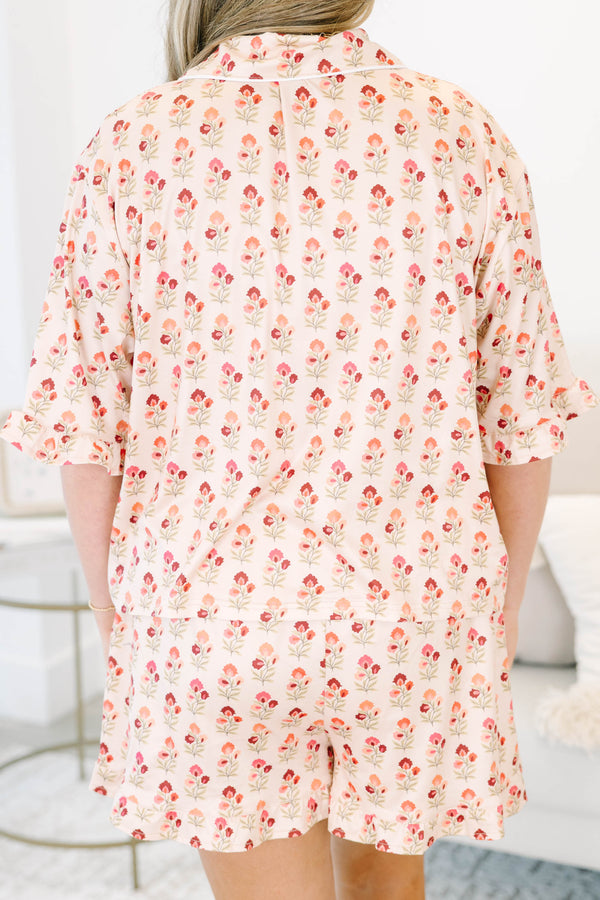 Plus Size cream floral pajama set with a button-down short sleeve top and matching ruffled shorts.