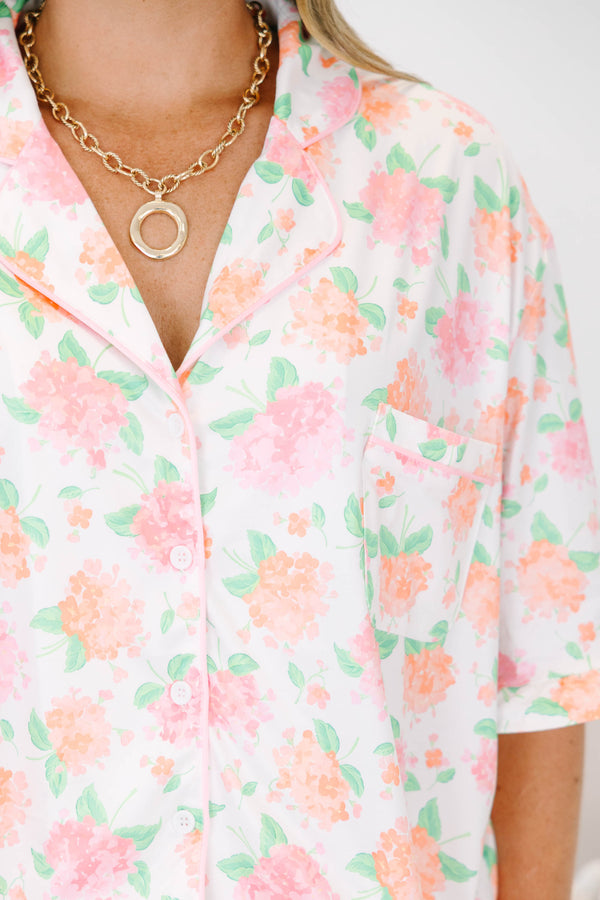 Plus Size pink hydrangea floral pajama set with a button-down short sleeve top and ruffled shorts.