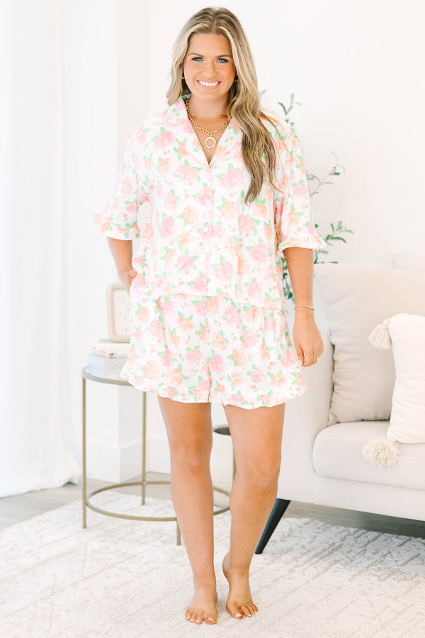 Plus Size pink hydrangea floral pajama set with a button-down short sleeve top and ruffled shorts.