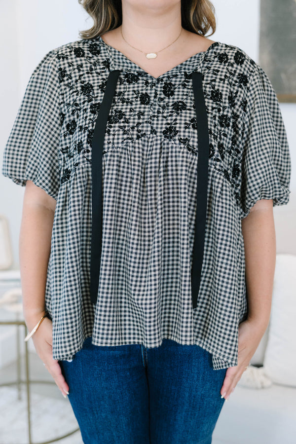 Plus Size black and white gingham top with floral embroidery, puff sleeves, and black ribbon ties.