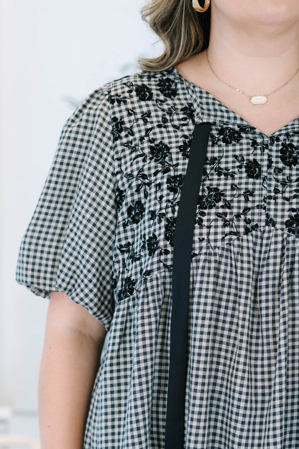 Plus Size black and white gingham top with floral embroidery, puff sleeves, and black ribbon ties.
