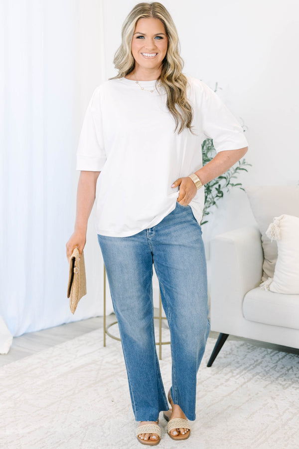 Plus Size high-rise, medium wash cropped straight-leg jeans with a raw hem.