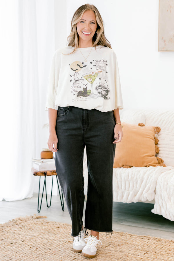 Chic Soul plus size clothing, ivory short sleeve boyfriend tee with a black cat, martini with eyeballs, bats, and other Halloween graphics on the front