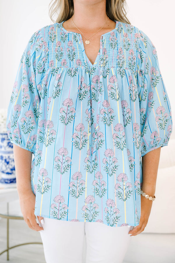 Plus Size blue floral smocked top with vertical stripes and elastic bubble sleeves.