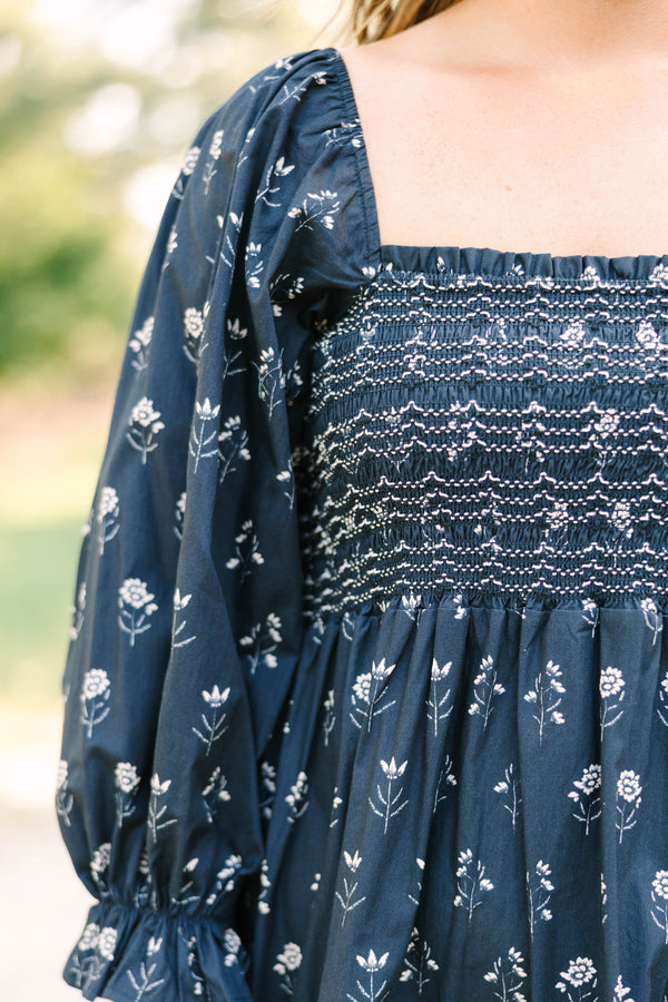 Plus Size black floral midi dress with a smocked bodice, square neckline, and long puff sleeves.