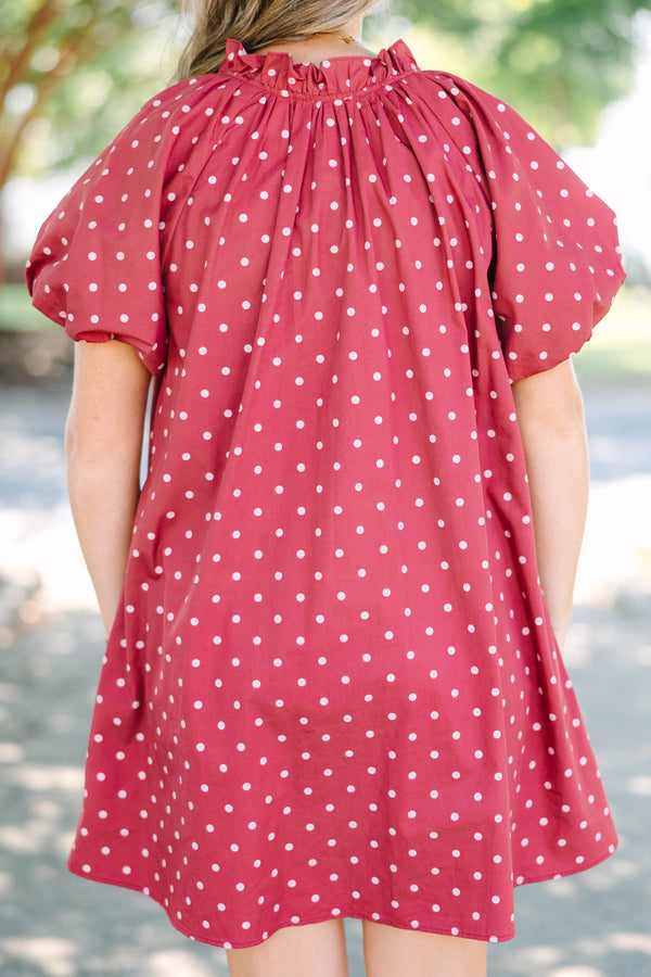 Plus size red polka-dot mini dress with a ruffled split V-neckline and flowy short sleeves.