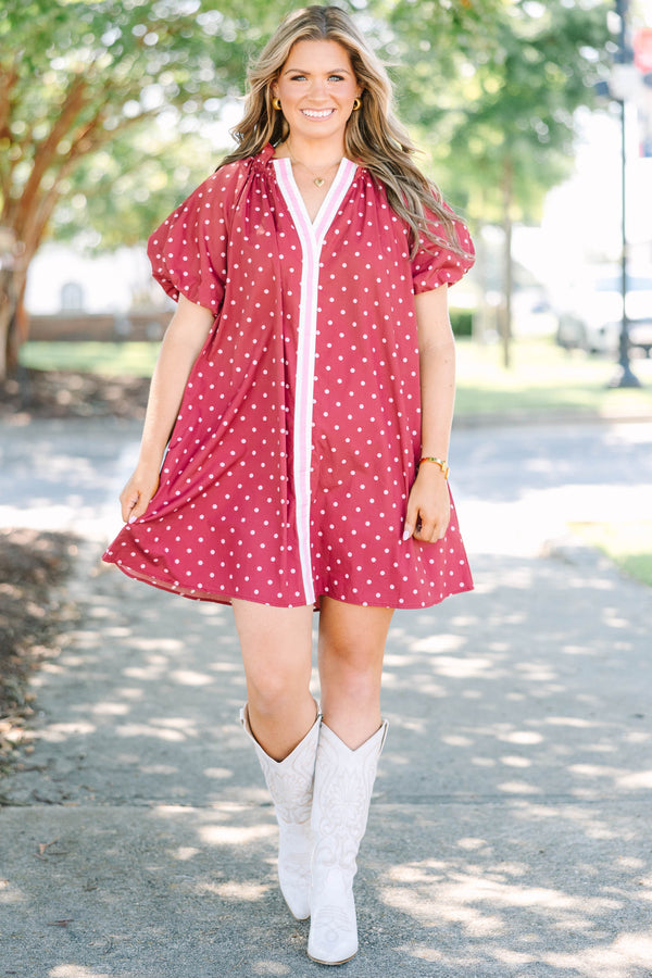 Plus size red polka-dot mini dress with a ruffled split V-neckline and flowy short sleeves.