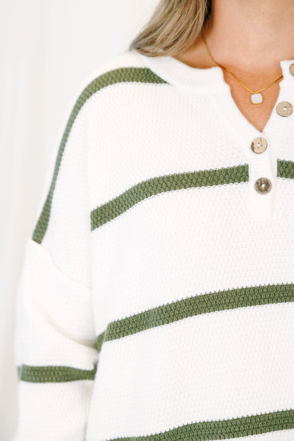 Plus size ivory knit sweater with green stripes, a button-up henley neckline, and a relaxed fit.