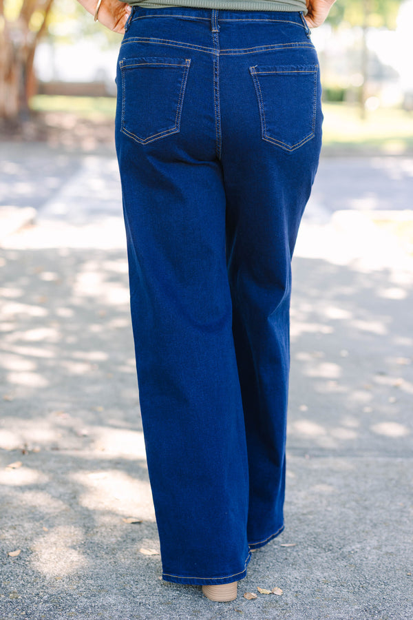 Plus size dark wash wide leg jeans with a high waist and stretchy denim fit.