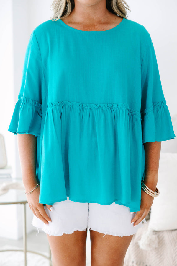Plus Size teal babydoll top with ruffled three-quarter sleeves and a round neckline.