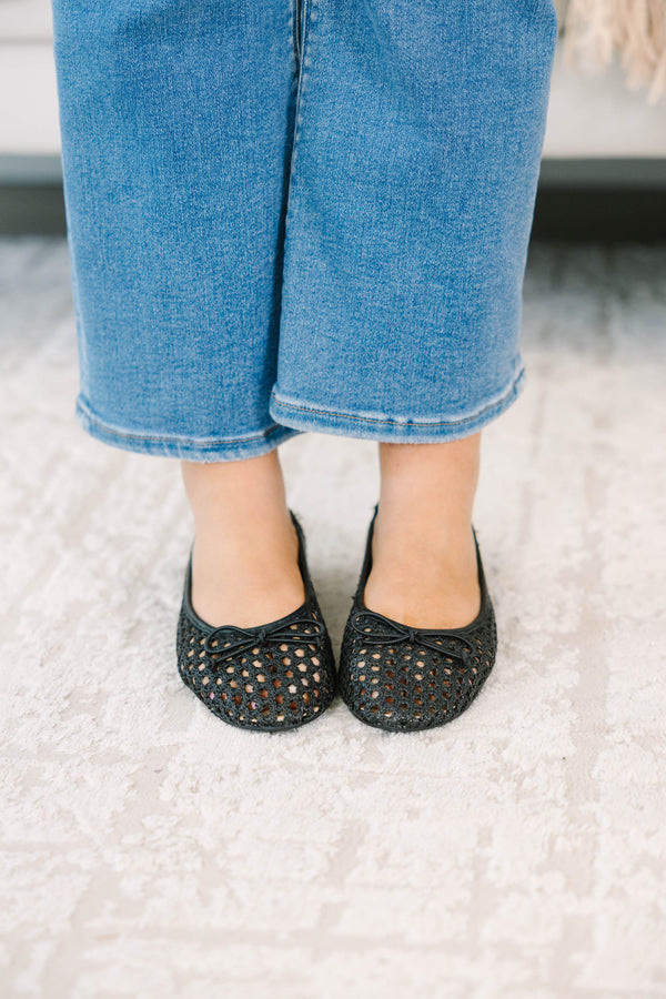 Plus Size black woven mesh ballet flats with a small bow detail paired with blue denim jeans.