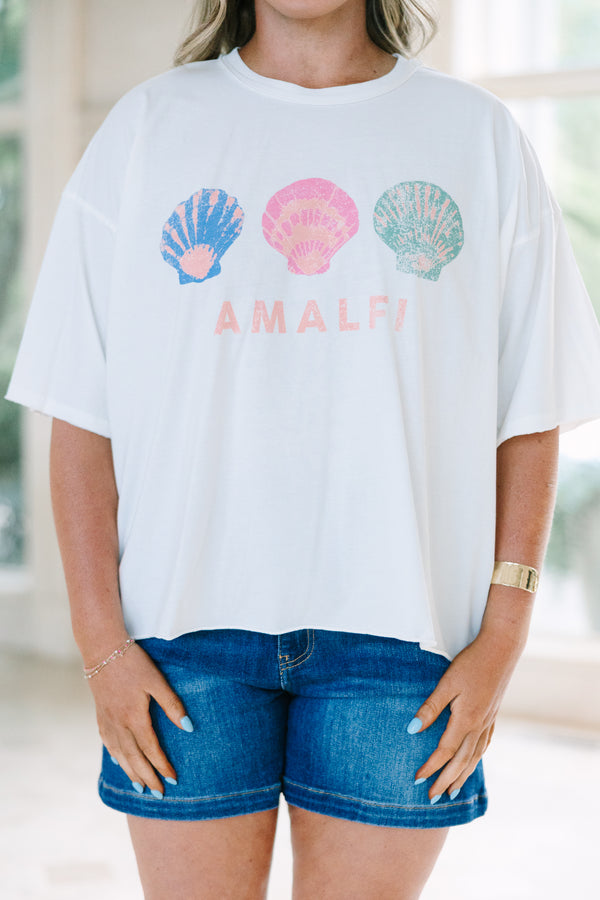 Plus Size white vintage wash tee with three colorful seashells and Amalfi text, paired with denim.