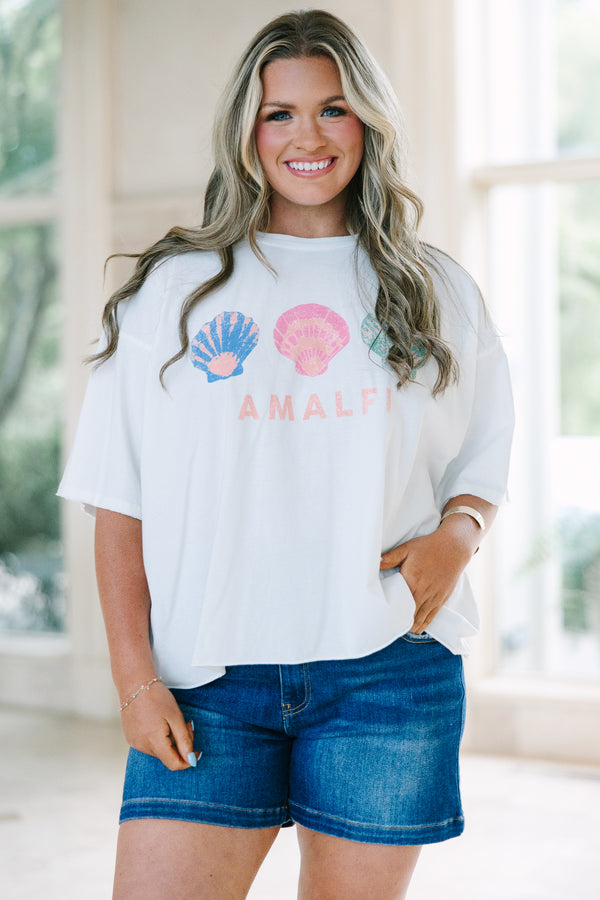 Plus Size white vintage wash tee with three colorful seashells and Amalfi text, paired with denim.