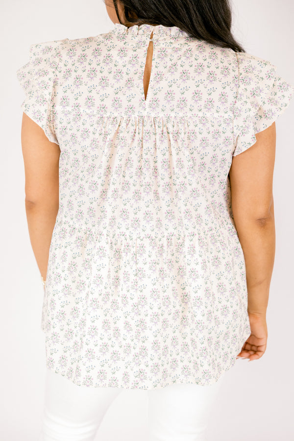 Chic Soul plus size clothing, cream top with flutter sleeves and a high neck that has ruffle detailing on the neckline of the top as well as a light floral pattern throughout the top 