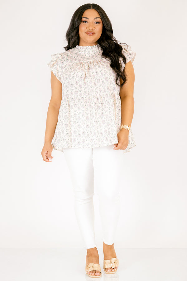 Chic Soul plus size clothing, cream top with flutter sleeves and a high neck that has ruffle detailing on the neckline of the top as well as a light floral pattern throughout the top 