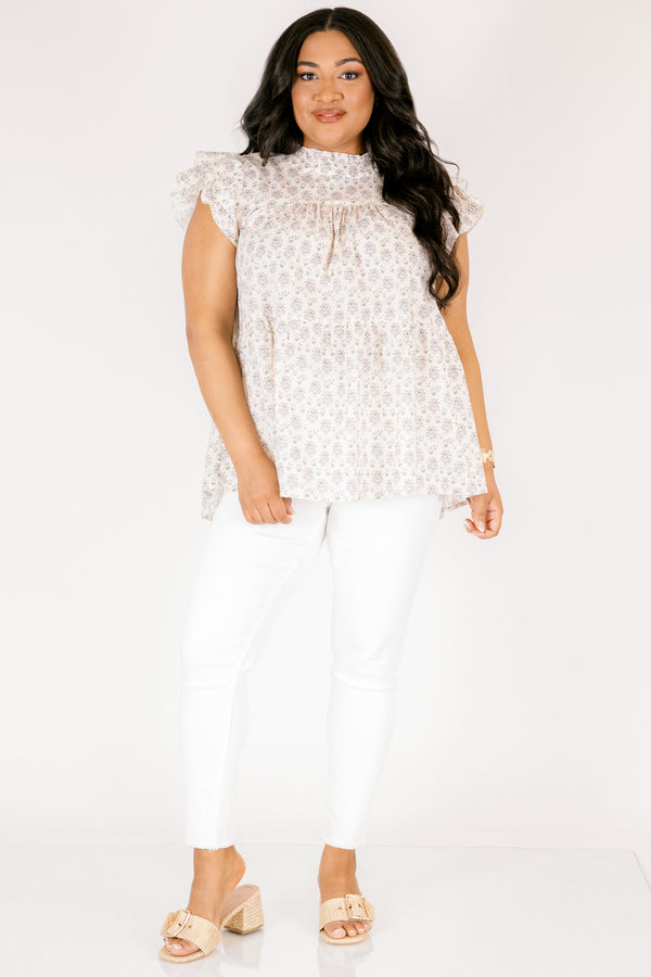 Chic Soul plus size clothing, cream top with flutter sleeves and a high neck that has ruffle detailing on the neckline of the top as well as a light floral pattern throughout the top 